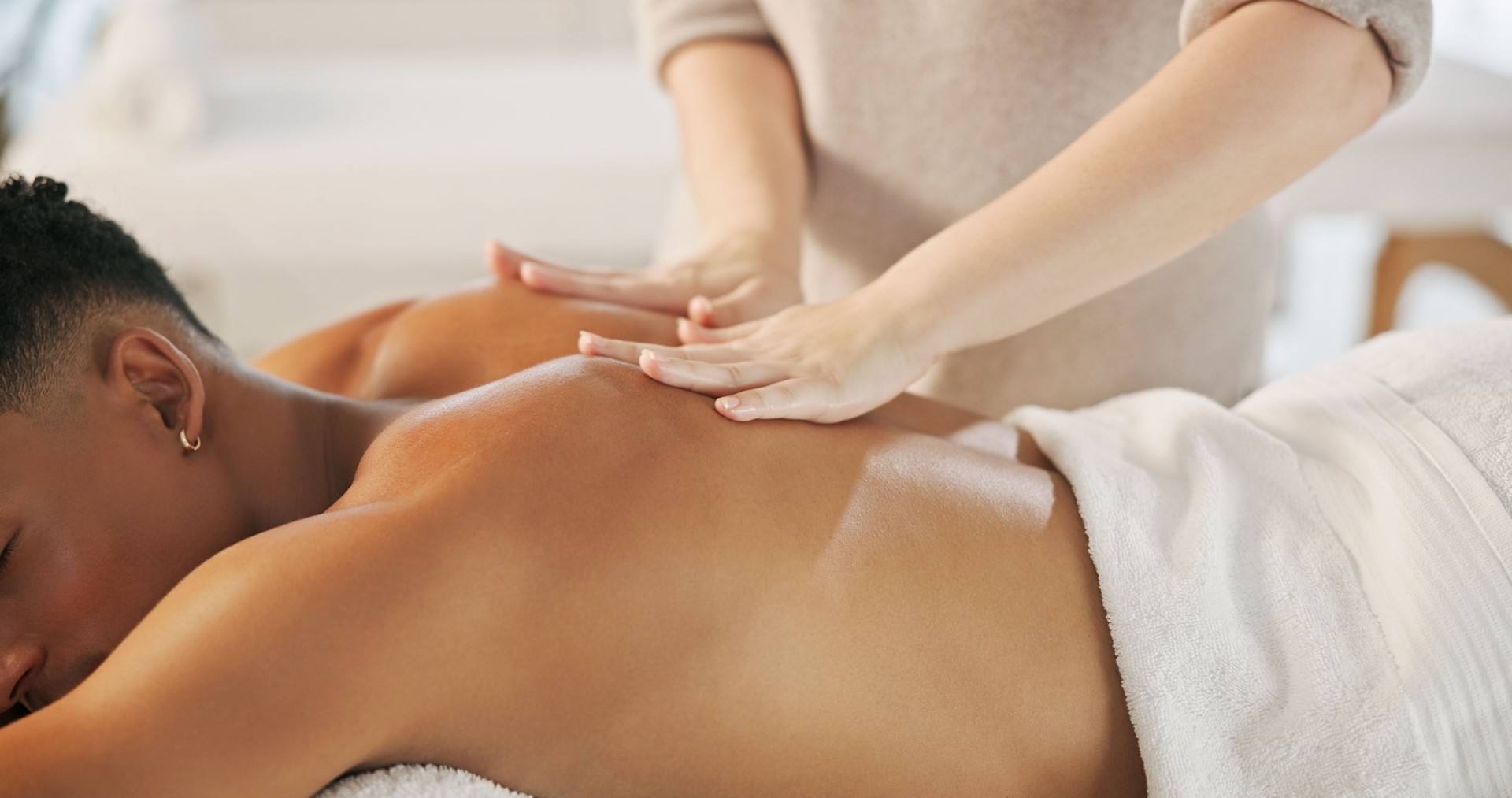 Relax, hands and man with back massage at spa for health, wellness and self care with luxury. Beauty, holistic and masseuse with male person for body treatment for skin healing at peaceful resort.